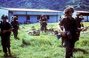 Members of the 82nd Airborne Division prepare to go out on patrol during Operation URGENT FURY. Two soldiers have M203 40 mm grenade launchers mounted on M16A1 rifles, one has a sni - DPLA - e1bf44b2507c350b638b38e4bc23a3d8