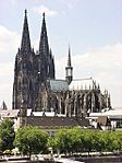 A large gothic style cathedral of grey to black colored stone.