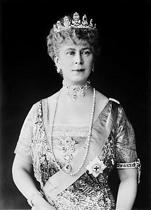 Mary in tiara and gown wearing a choker necklace and a string of diamonds